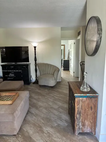 a view of a dining room with furniture and a chandelier