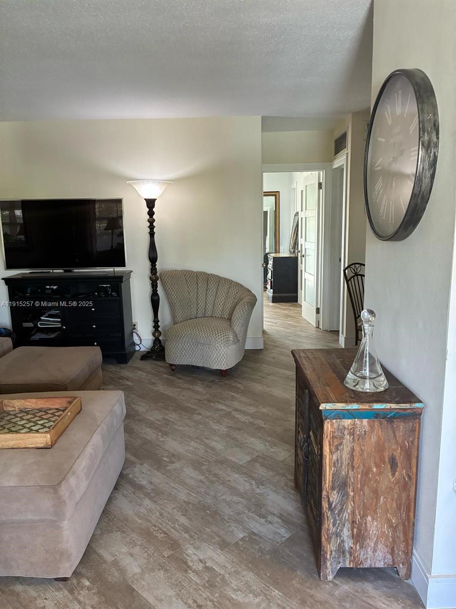 2050 Northeast 39th Street, Unit 311 Lighthouse Point, FL 33064 - Photo 3 of 17 a living room with furniture and a flat screen tv