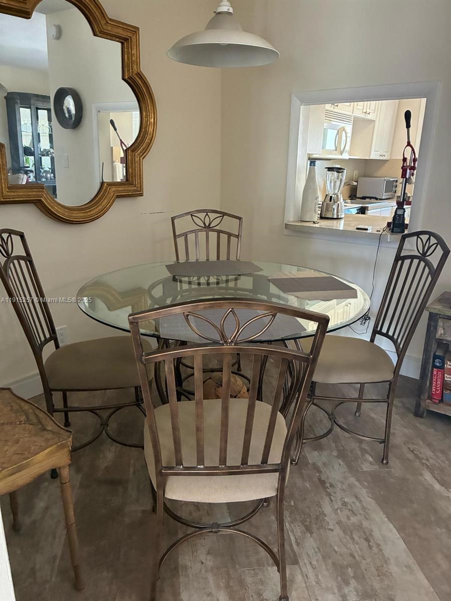 2050 Northeast 39th Street, Unit 311 Lighthouse Point, FL 33064 - Photo 4 of 17 a view of a dining room with furniture and a chandelier