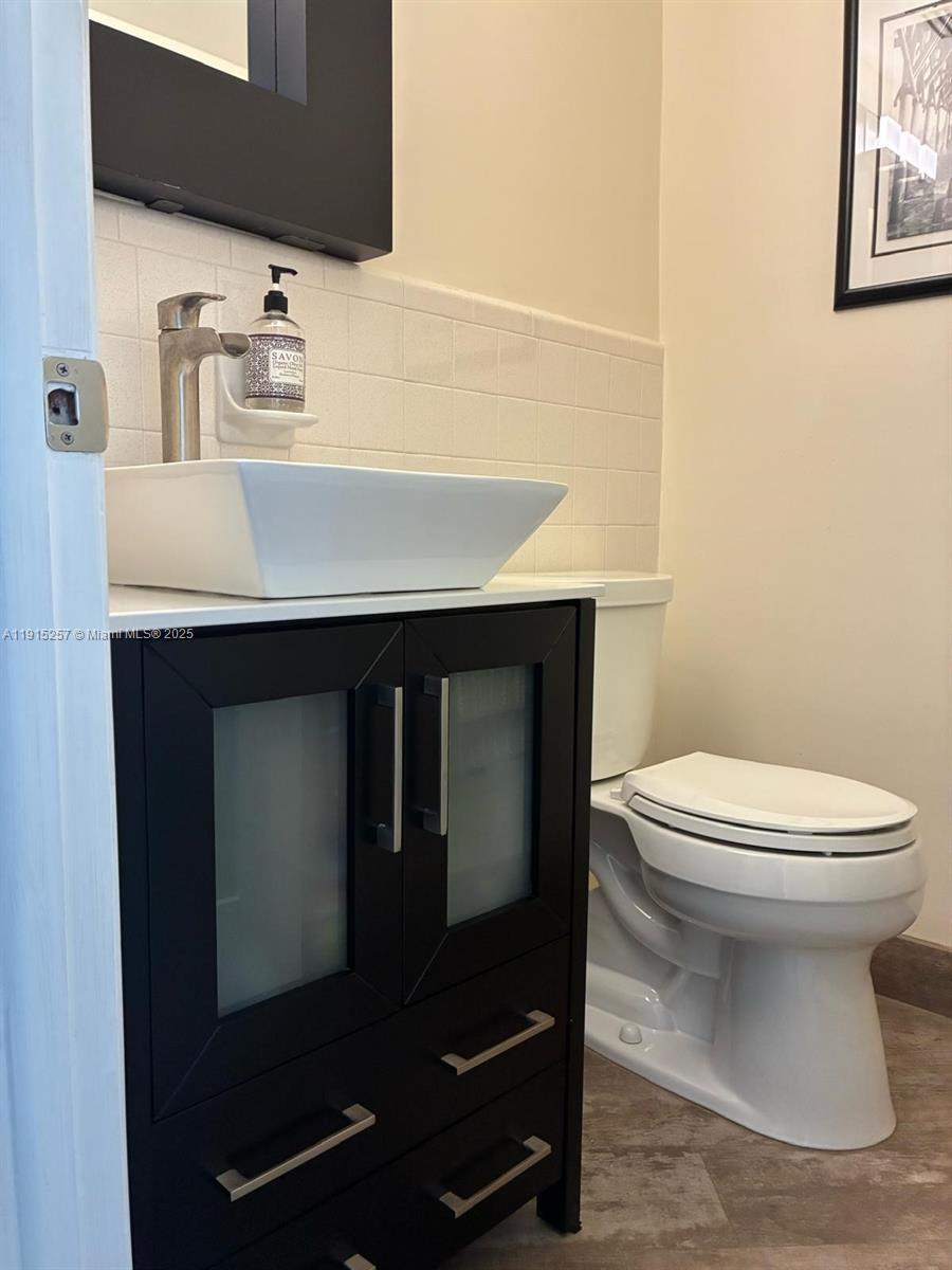 2050 Northeast 39th Street, Unit 311 Lighthouse Point, FL 33064 - Photo 7 of 17 a bathroom with a sink and a toilet