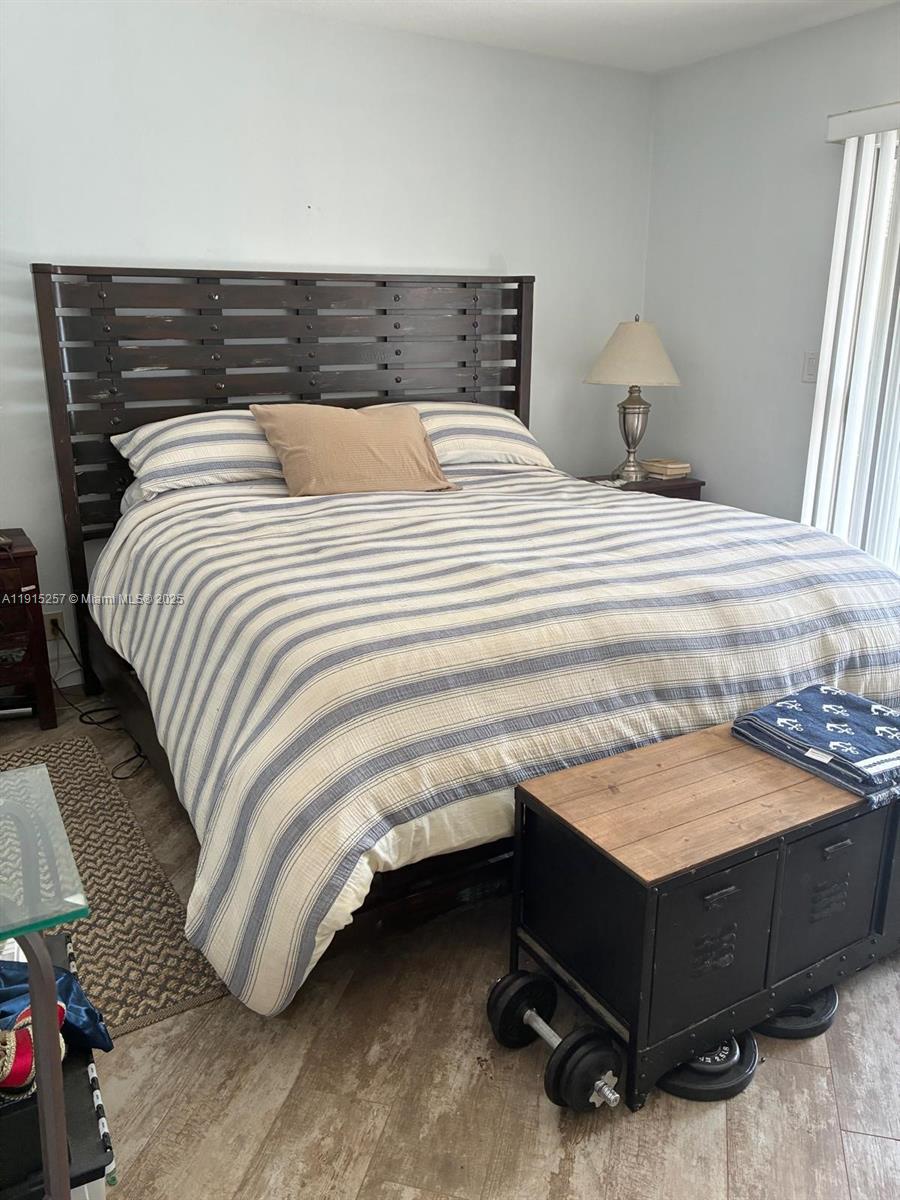 2050 Northeast 39th Street, Unit 311 Lighthouse Point, FL 33064 - Photo 8 of 17 a bedroom with a bed and dresser