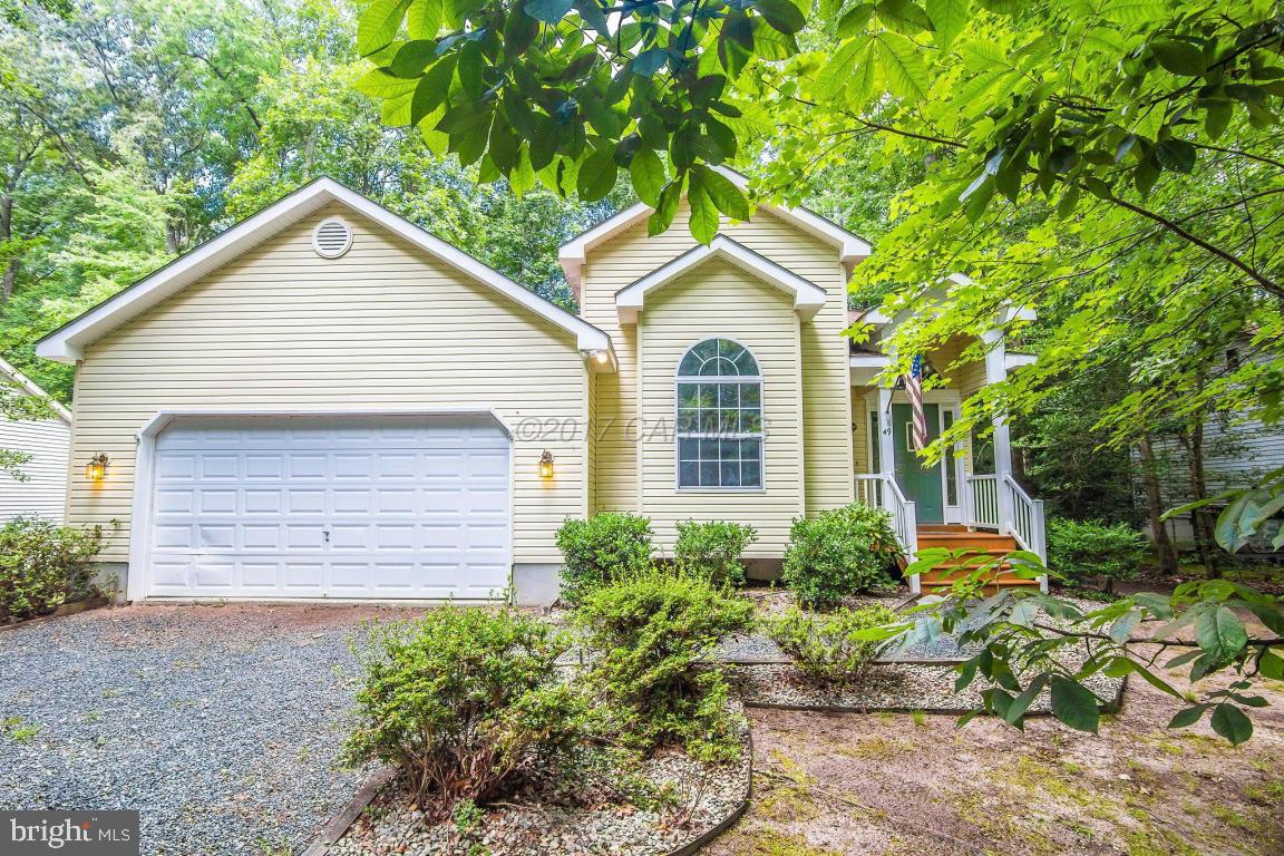 49 Beaconhill Road Ocean Pines, MD 21811 - Photo 1 of 62 a front view of a house with a yard and garage