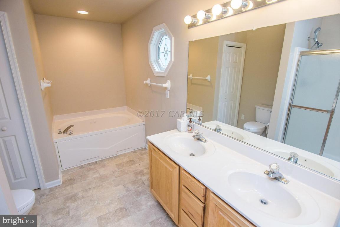 49 Beaconhill Road Ocean Pines, MD 21811 - Photo 12 of 62 a bathroom with a double vanity sink mirror and bathtub