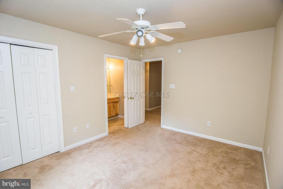 49 Beaconhill Road Ocean Pines, MD 21811 - Photo 14 of 62 an empty room with fan and a ceiling fan