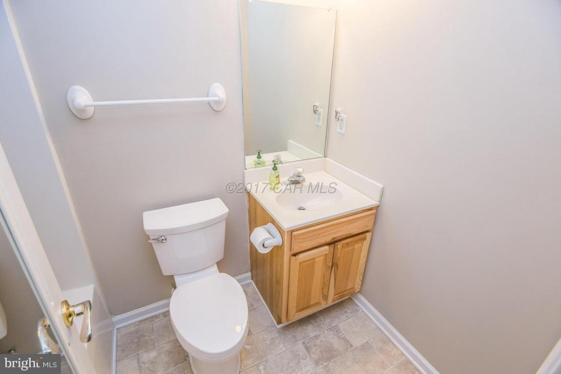 49 Beaconhill Road Ocean Pines, MD 21811 - Photo 16 of 62 a white toilet sitting next to a bathroom sink