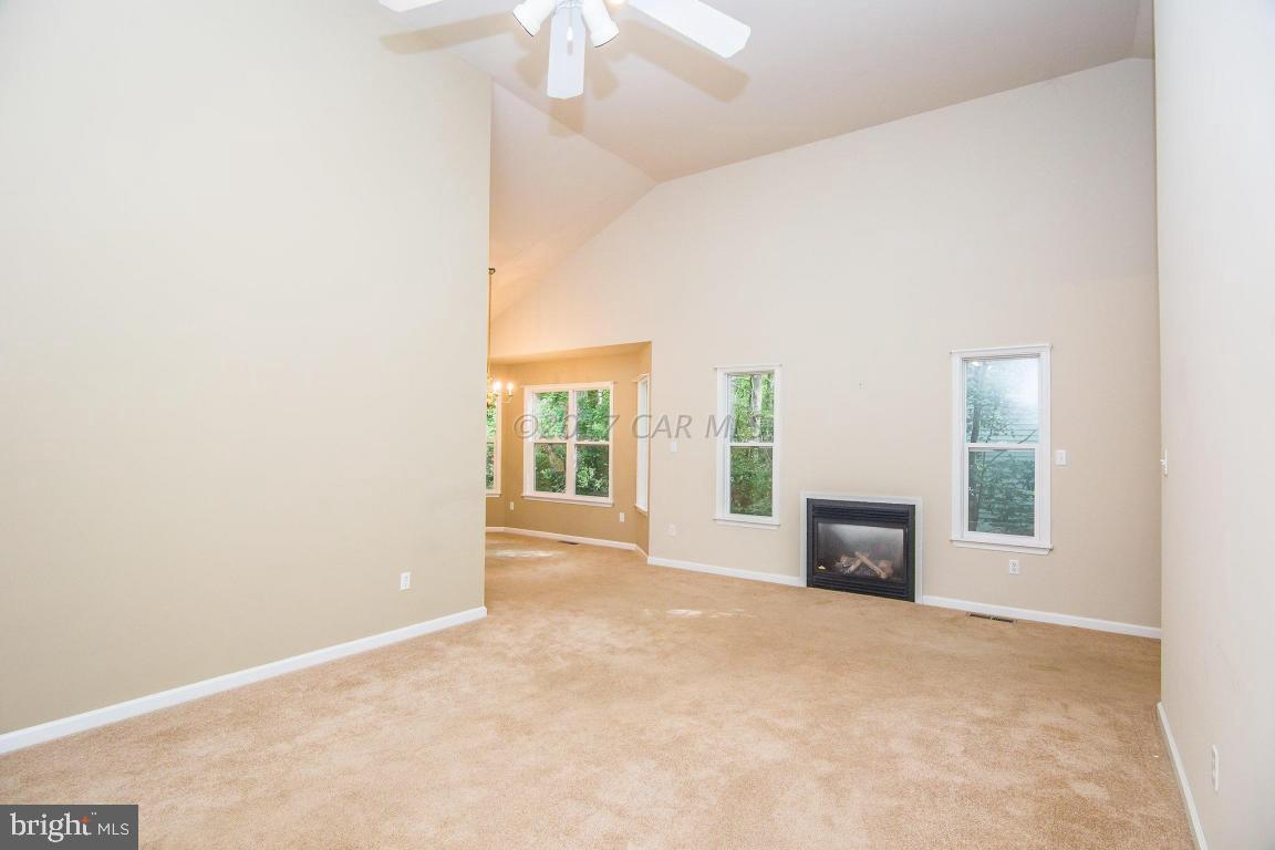 49 Beaconhill Road Ocean Pines, MD 21811 - Photo 3 of 62 an empty room with furniture and a fireplace