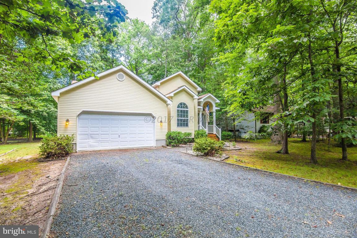 49 Beaconhill Road Ocean Pines, MD 21811 - Photo 25 of 62 a front view of a house with a yard and garage