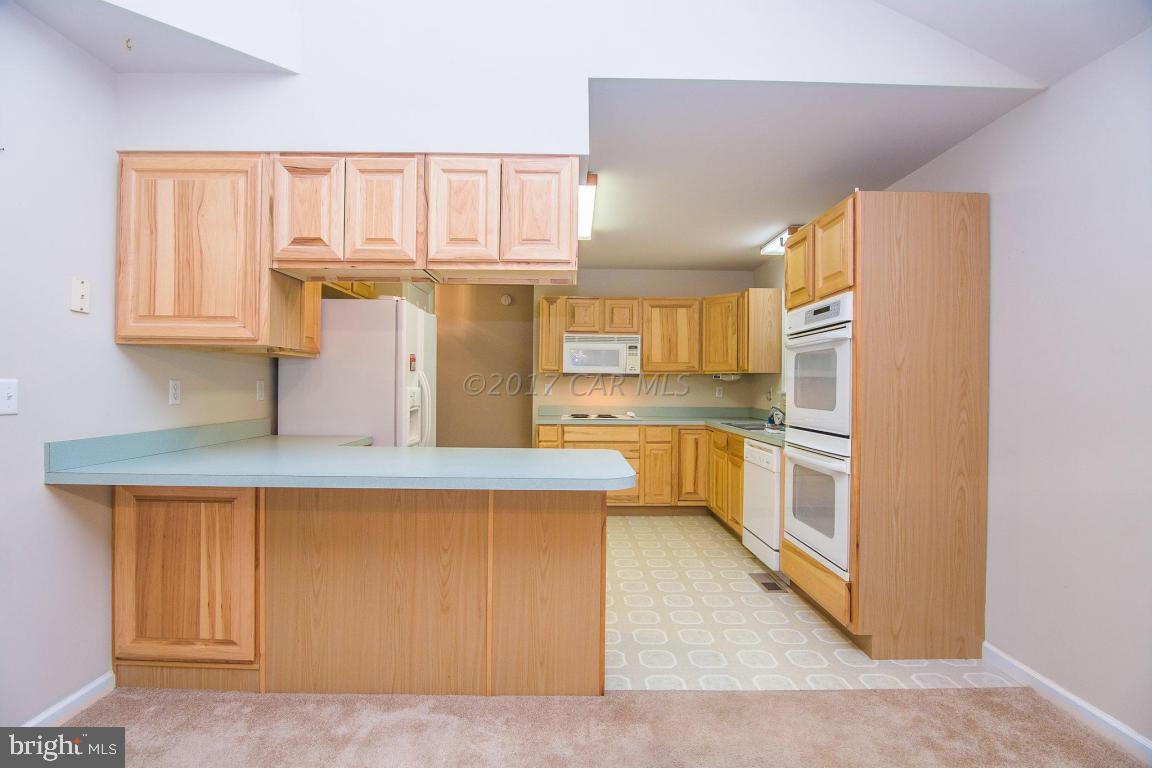 49 Beaconhill Road Ocean Pines, MD 21811 - Photo 31 of 62 a kitchen with a refrigerator and window