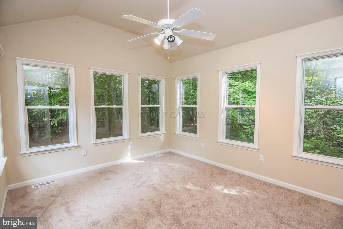 49 Beaconhill Road Ocean Pines, MD 21811 - Photo 35 of 62 a view of an empty room with a window and a ceiling fan