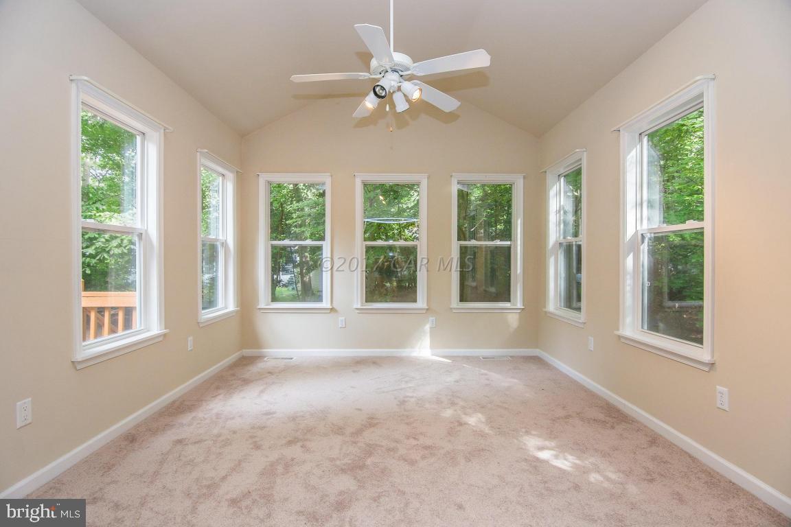 49 Beaconhill Road Ocean Pines, MD 21811 - Photo 9 of 62 a view of an empty room with a window and a ceiling fan