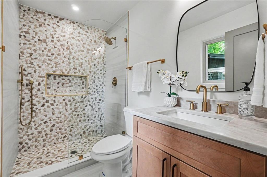 2700 Hawaii Court Decatur, GA 30033 - Photo 19 of 31 a bathroom with a granite countertop sink a toilet and a mirror