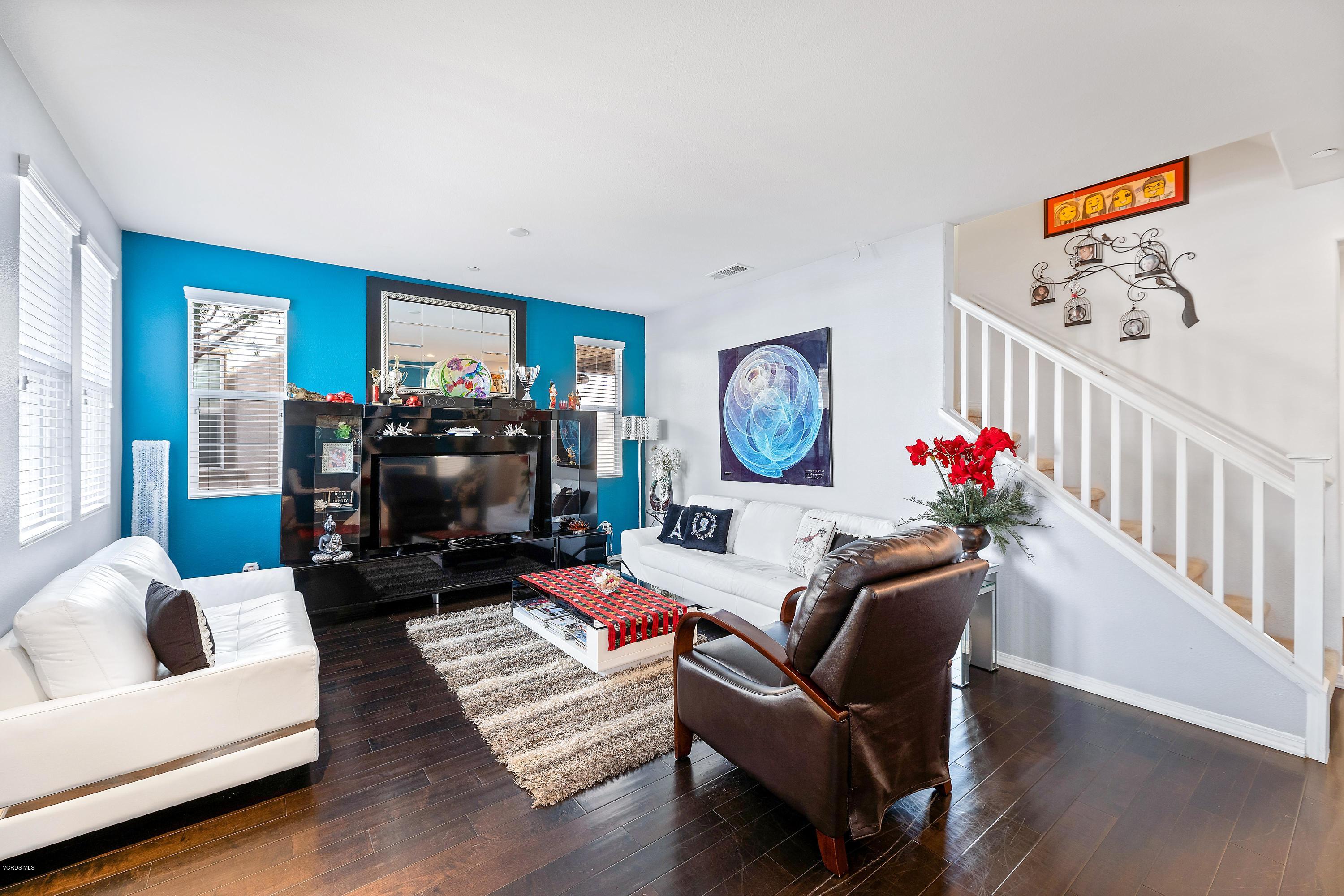 3144 North Ventura Road Oxnard, CA 93036 - Photo 2 of 18 a living room with furniture a flat screen tv and a fireplace