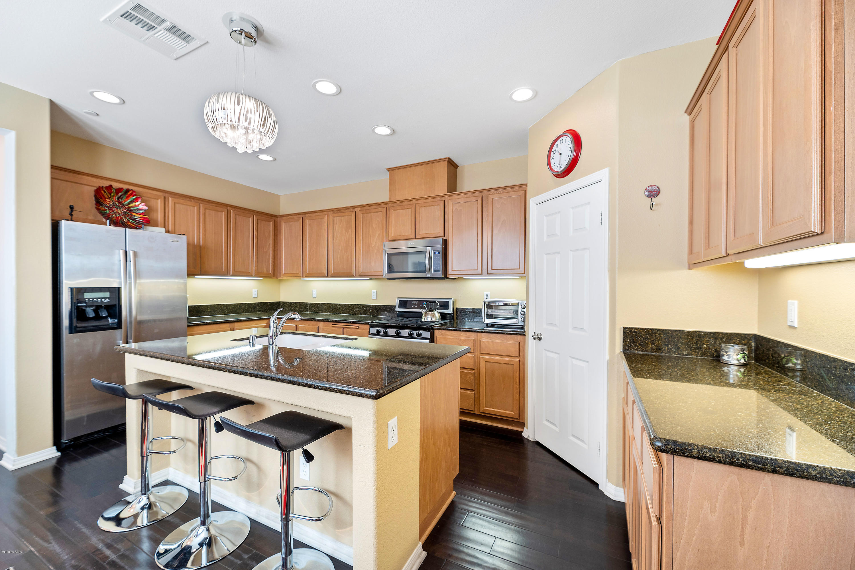 3144 North Ventura Road Oxnard, CA 93036 - Photo 3 of 18 a kitchen with granite countertop a sink a counter top space stainless steel appliances and cabinets