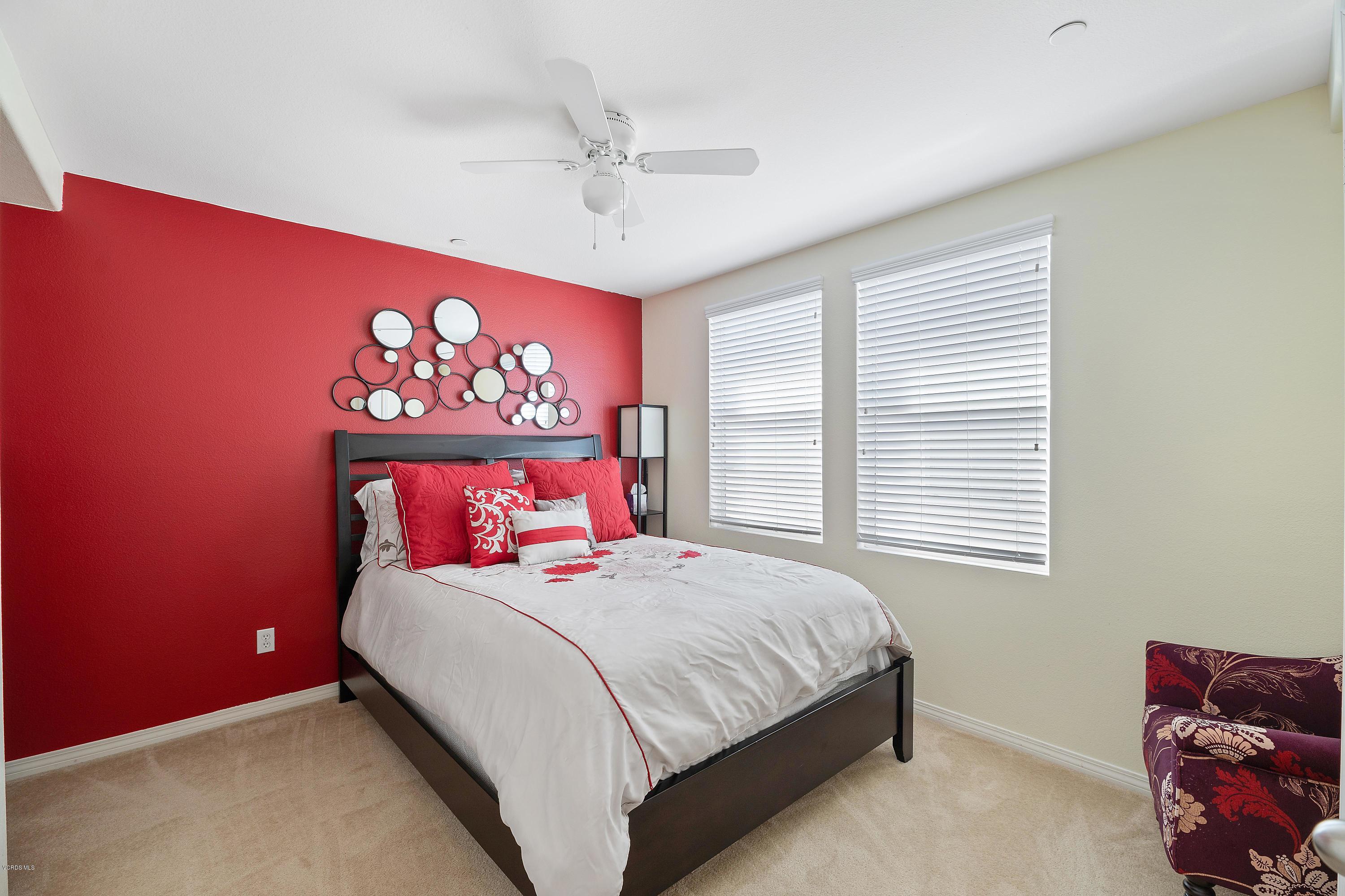 3144 North Ventura Road Oxnard, CA 93036 - Photo 9 of 18 a bedroom with a bed and a chandelier