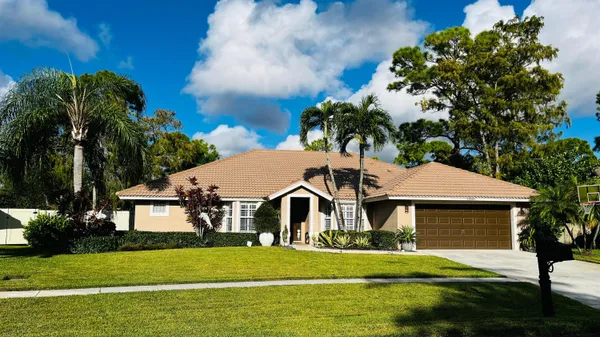 a front view of a house with a garden and yard