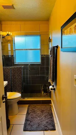 a bathroom with a toilet and a shower