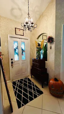 a living room with a chandelier furniture and a window
