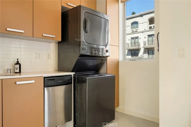 a kitchen with stainless steel appliances granite countertop a refrigerator and a stove