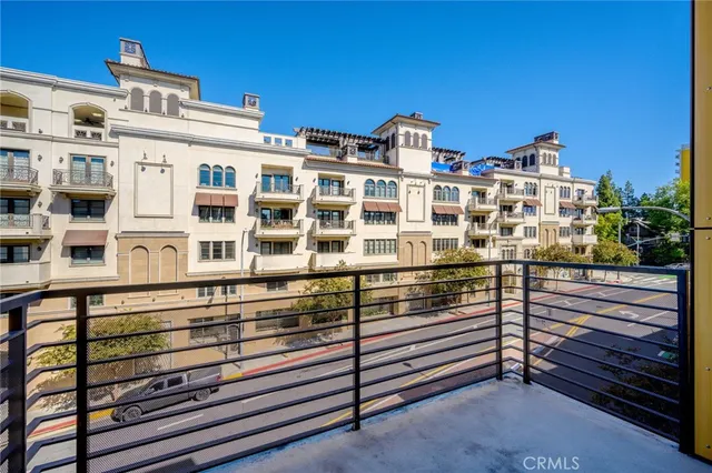 a view of a balcony with wooden floor and fence