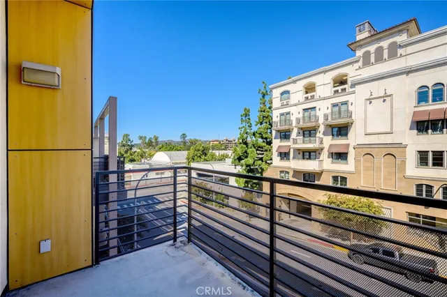 a view of a balcony with wooden floor and fence