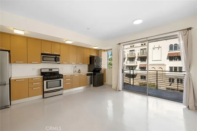 a kitchen with stainless steel appliances refrigerator sink and stove