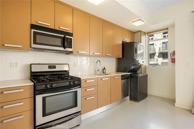 a kitchen with stainless steel appliances granite countertop a refrigerator sink and cabinets