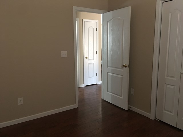 260 Autumn Ridge Court Gray, GA 31032 - Photo 22 of 28 an empty room with wooden floor and closet