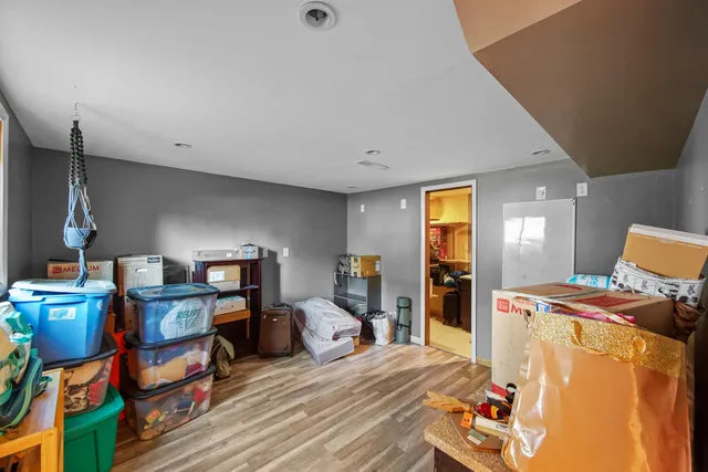 a bed room with furniture and wooden floor