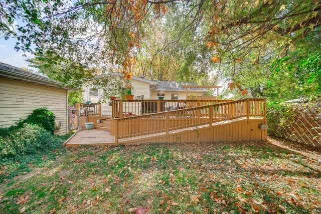 a view of a house with backyard and trees
