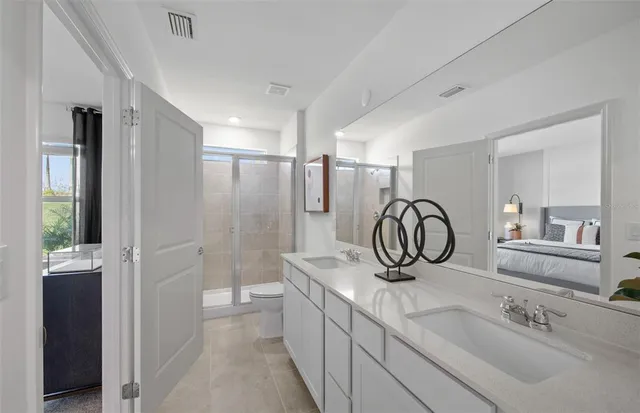 a bathroom with a sink double vanity and a mirror
