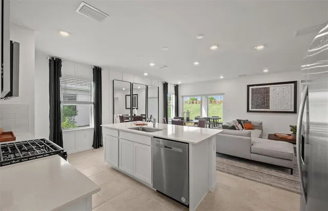 a large white kitchen with a large window