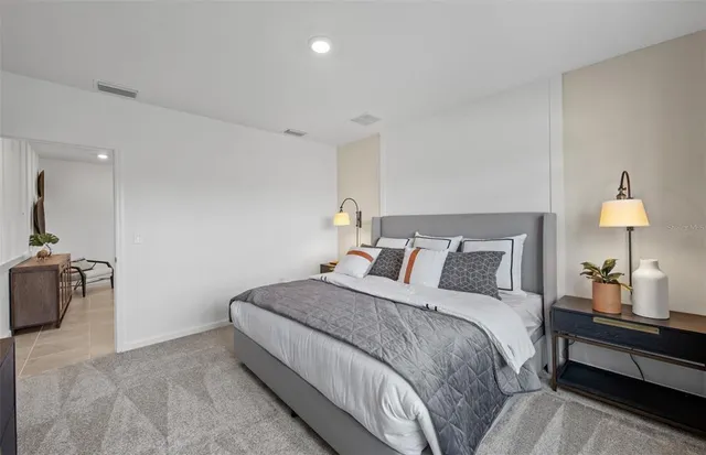 a bedroom with a bed and a lamp