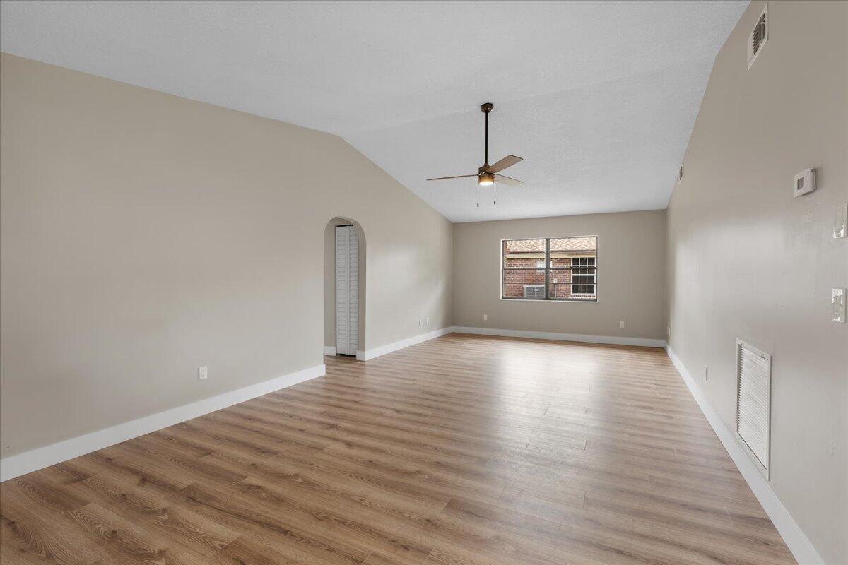 2138 Southeast Dolphin Road Port St. Lucie, FL 34952 - Photo 15 of 31 a view of an empty room with window and wooden floor