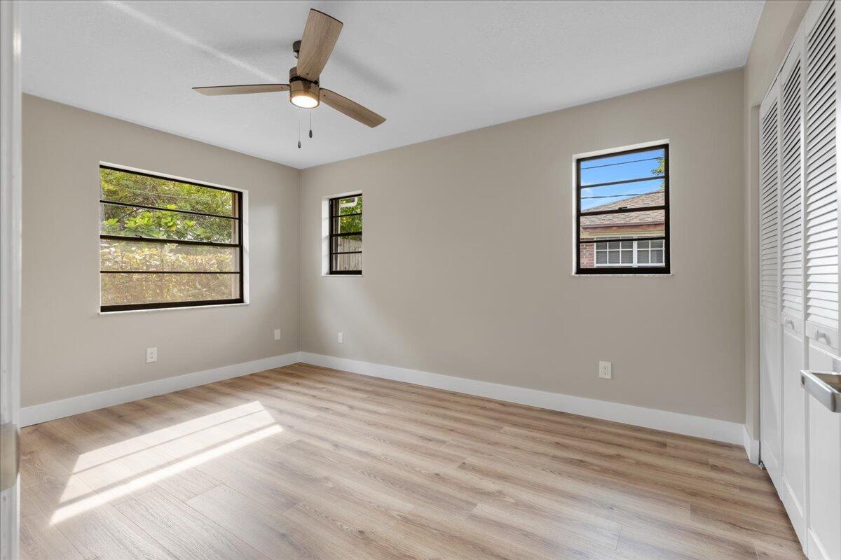 2138 Southeast Dolphin Road Port St. Lucie, FL 34952 - Photo 19 of 31 a view of an empty room with window and wooden floor