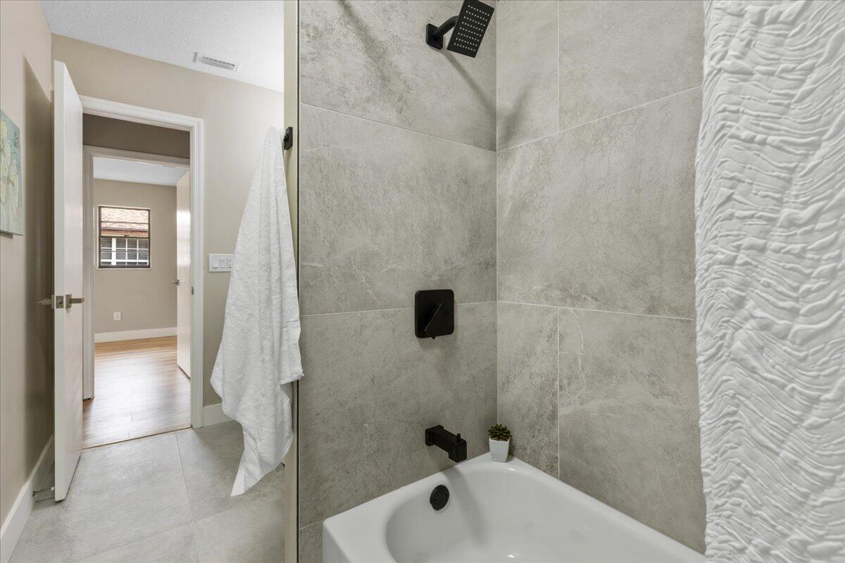 2138 Southeast Dolphin Road Port St. Lucie, FL 34952 - Photo 22 of 31 a bathroom with a shower and a sink