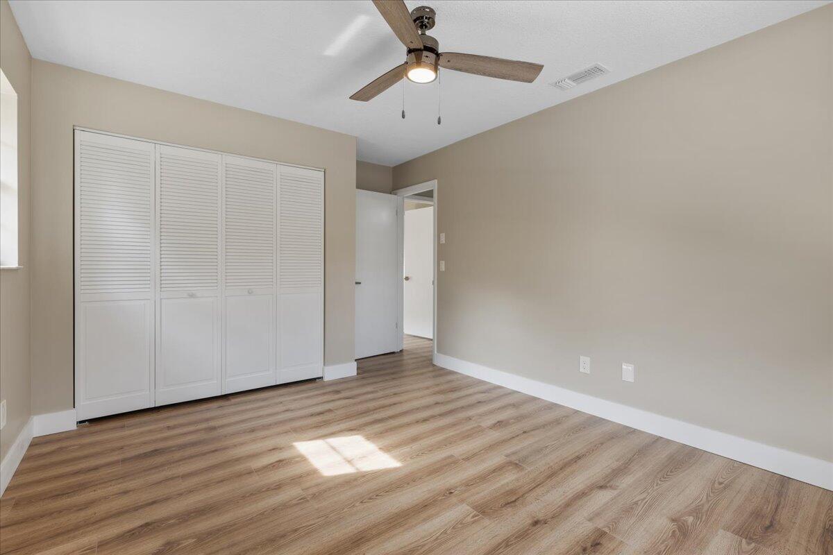 2138 Southeast Dolphin Road Port St. Lucie, FL 34952 - Photo 24 of 31 a view of an empty room with wooden floor