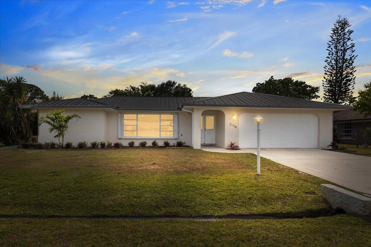 2138 Southeast Dolphin Road Port St. Lucie, FL 34952 - Photo 26 of 31 a view of an house with pool and yard