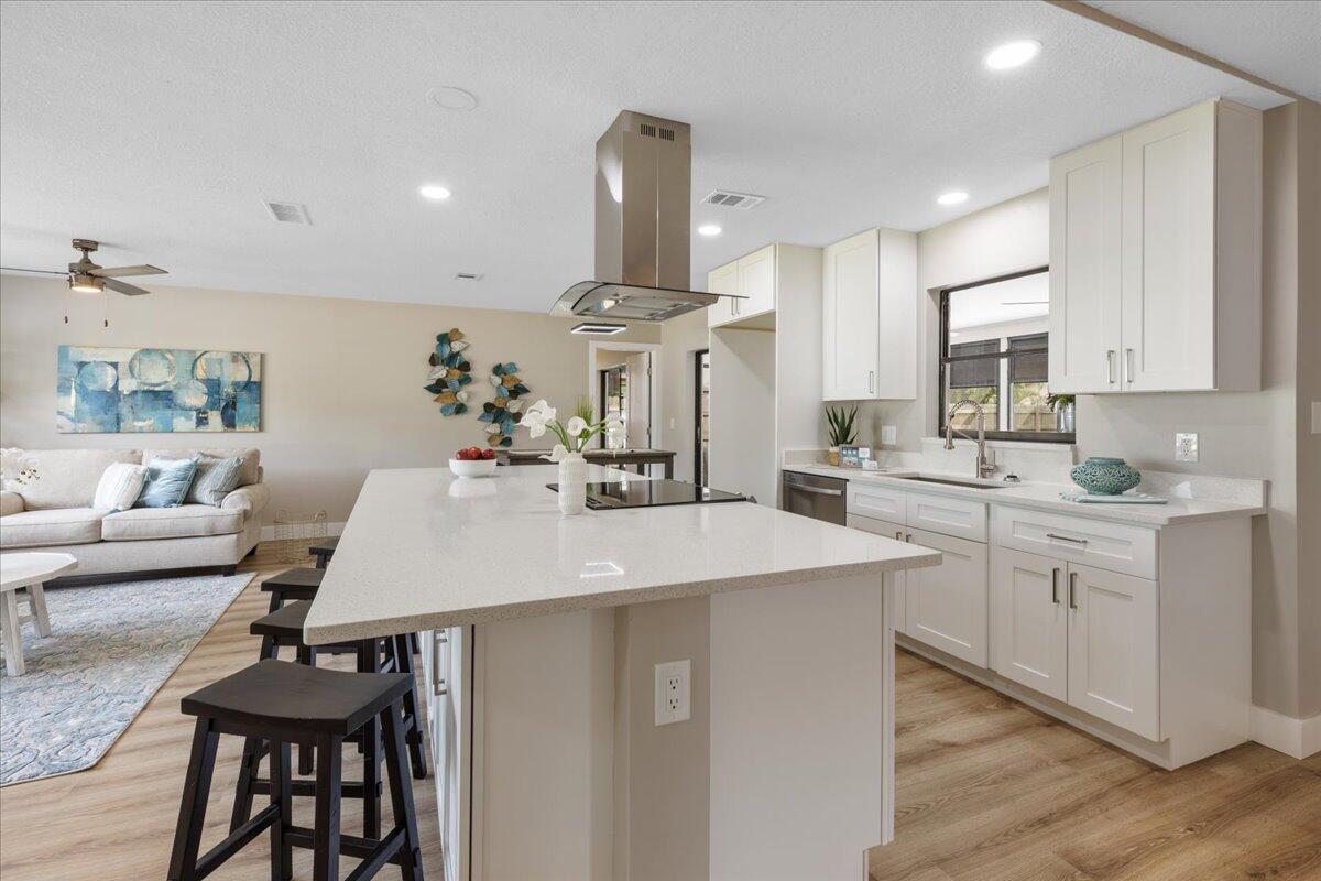 2138 Southeast Dolphin Road Port St. Lucie, FL 34952 - Photo 5 of 31 a kitchen with stainless steel appliances a sink stove and wooden floor