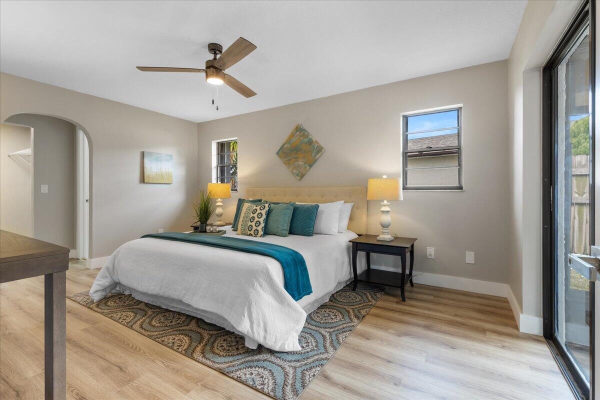 2138 Southeast Dolphin Road Port St. Lucie, FL 34952 - Photo 7 of 31 a bedroom with a bed and wooden floor