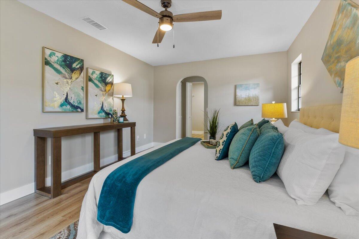 2138 Southeast Dolphin Road Port St. Lucie, FL 34952 - Photo 8 of 31 a bedroom with a bed and a painting on the wall