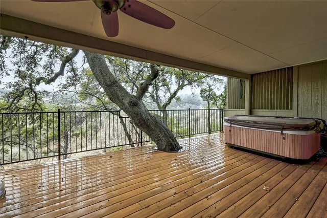a living room with large windows and wooden floor