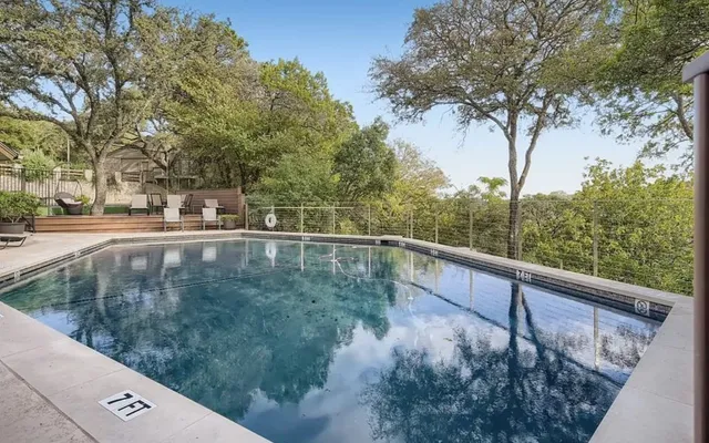 a view of a balcony with yard