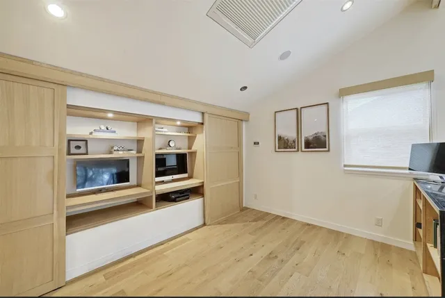 a view of a hallway with an empty room and a fireplace