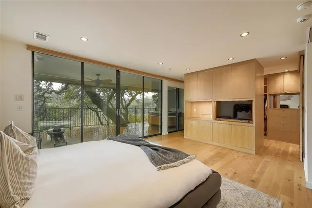 a bedroom with a large bed and a large window