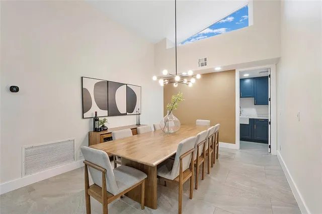 a kitchen with kitchen island a counter top space cabinets and stainless steel appliances