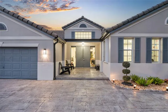 a view of a building with large windows and plants