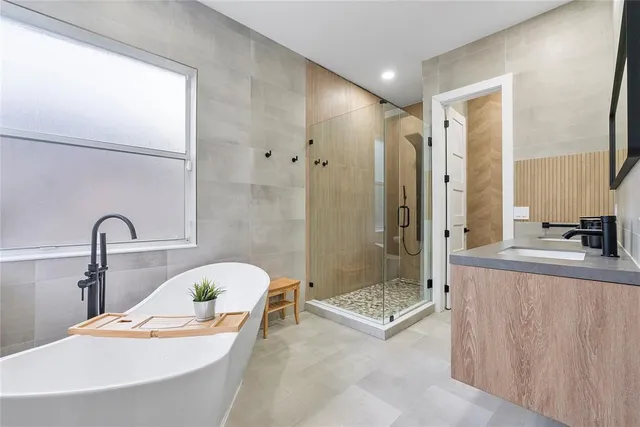 a view of a patio with a table chairs and a floor to ceiling window