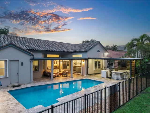 an aerial view of residential houses with outdoor space and trees