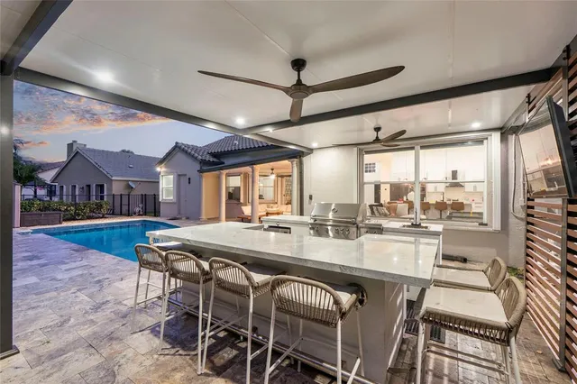 an aerial view of residential houses with outdoor space and trees