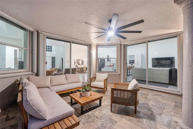 an aerial view of residential houses with outdoor space and ocean view